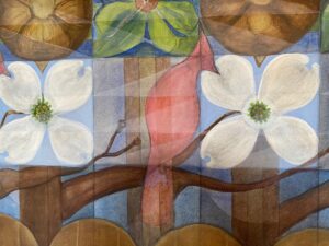 Close up of a red cardinal between two white dogwood flowers from the mural "North Carolina Belongs to Children" by NC artists James and John Biggers.