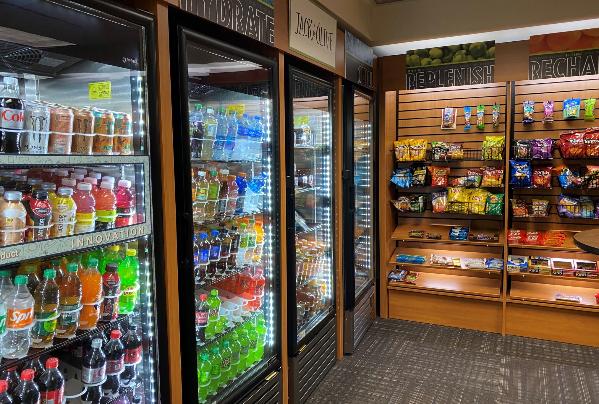 Shelves of refrigerated drinks and snacks