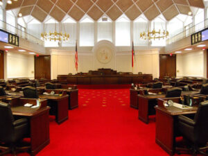 NC Senate Chamber with bright red carpet.